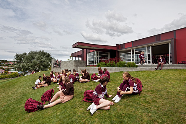 Ogilvie High School Student Centre, students sitting outside on grass